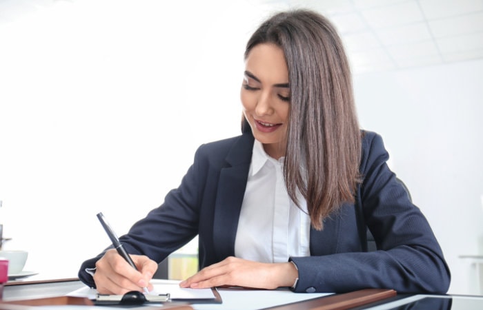 An attorney woman writing a business contract