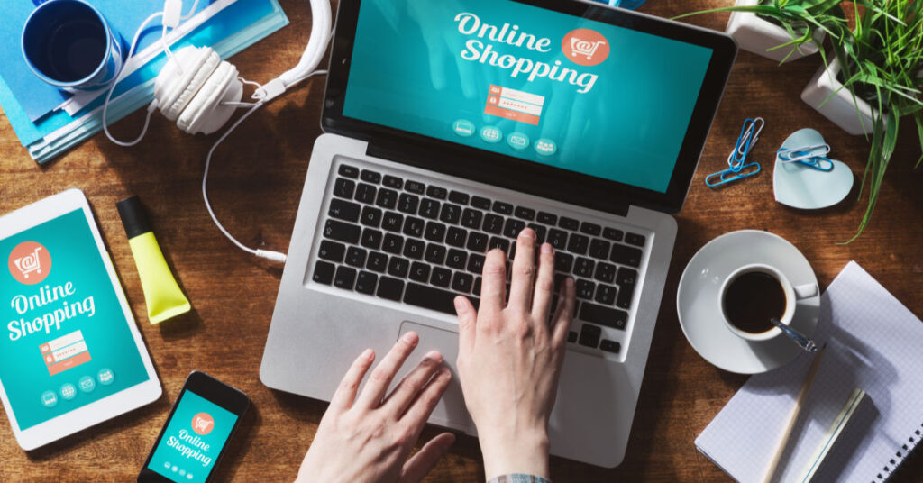 An image of a laptop, coffee cup and tablet opened on a page that says online shopping
